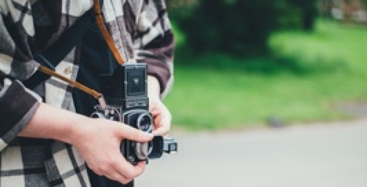 Person holding a DSLR camera